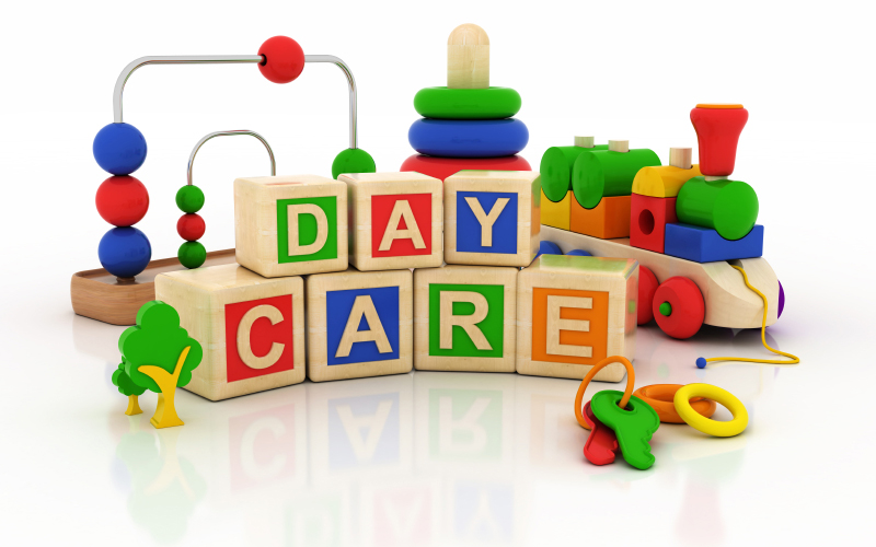Colorful daycare toys and blocks arranged neatly with “DAY CARE” spelled out.